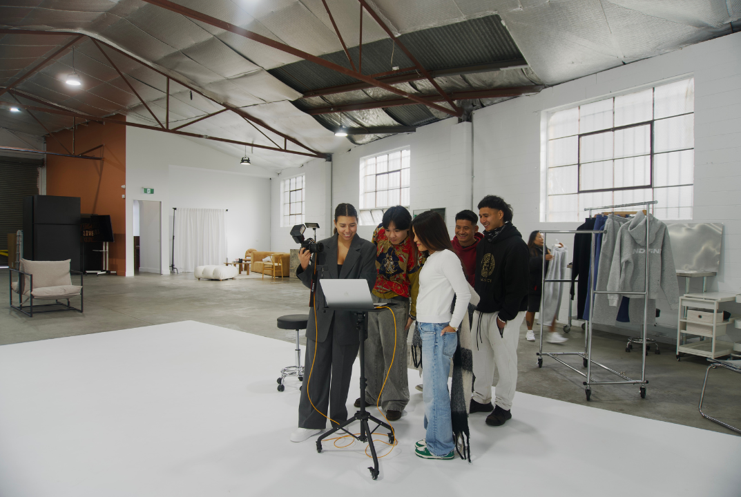 Kristy from Blanqt Studio showing photography work to clients in a creative studio.